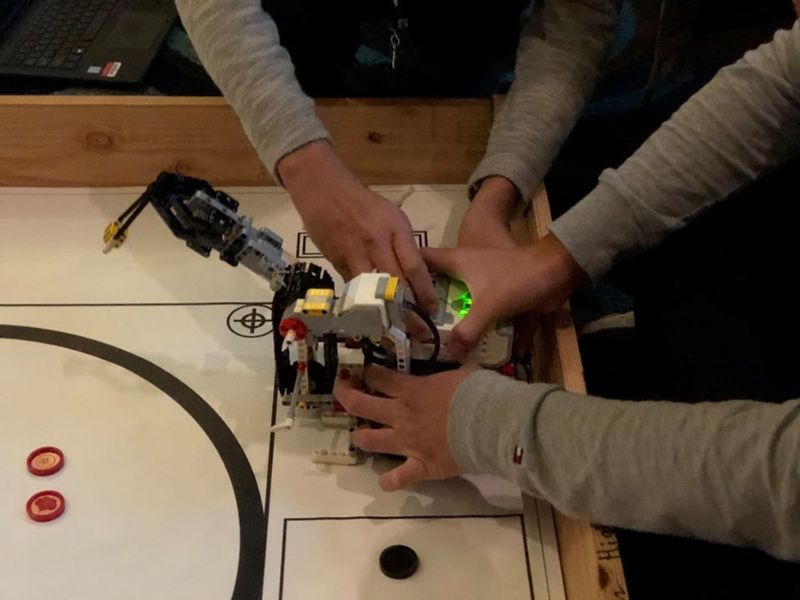Students holding a robot at the TCEA competition.